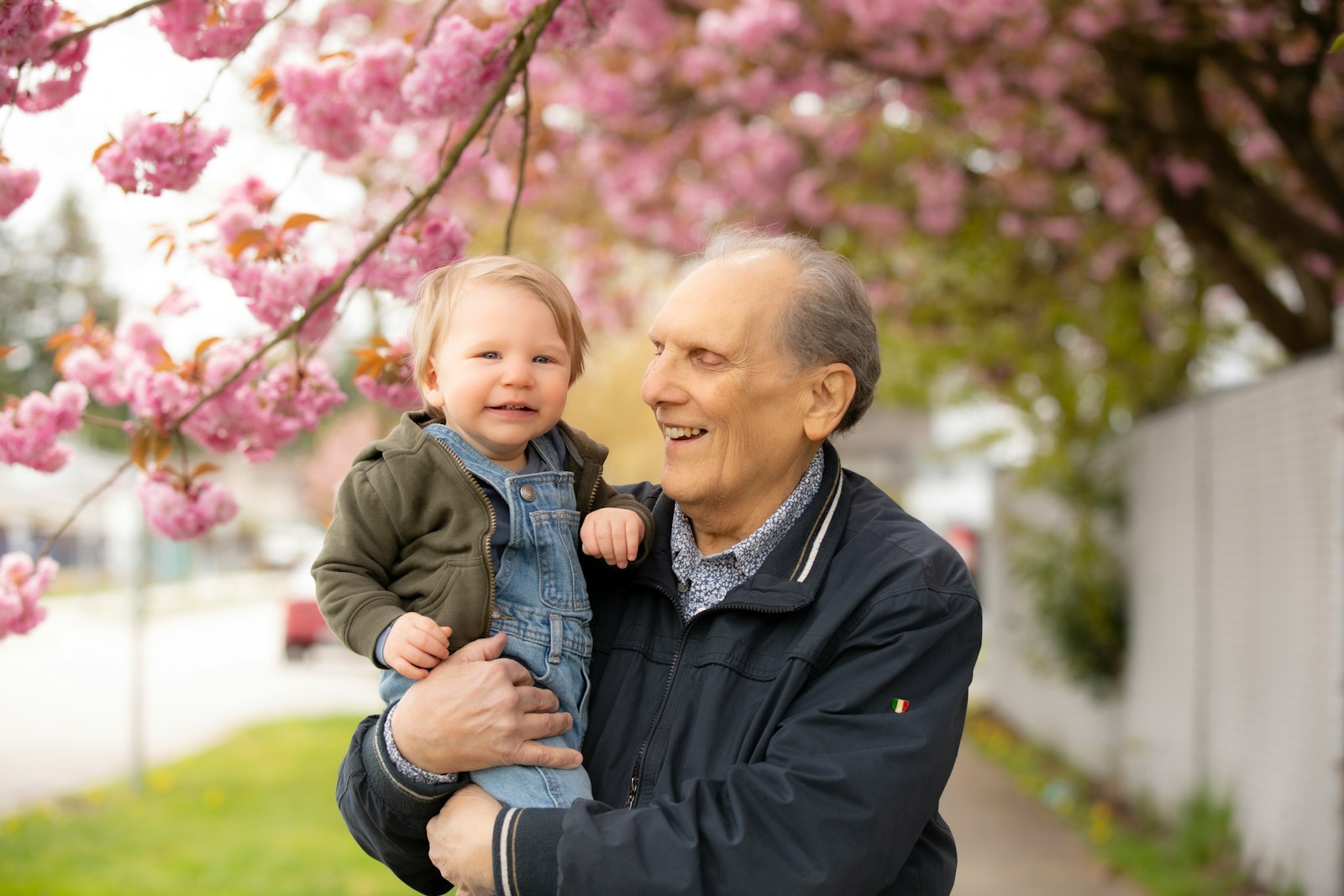 a man holding a little boy in his arms